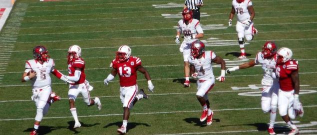 Rutgers' quarterback runs for a long gain against Nebraska.