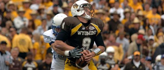 They Wyoming Cowboys quarterback defending the ball against Air Force Academy. 