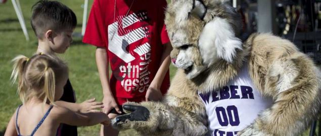 Children greet a Weber State University mascot.